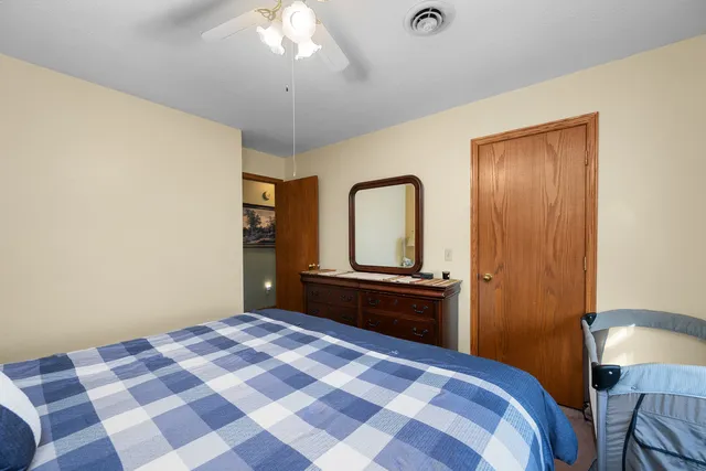 a bedroom with a bed and a chandelier