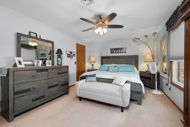 a bedroom with a bed closet and flat tv screen