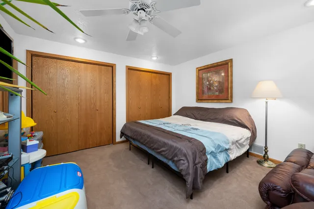 a bedroom with furniture and a flat screen tv