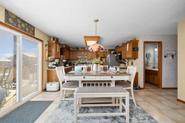 a kitchen with stainless steel appliances granite countertop a stove top oven a sink dishwasher and a refrigerator