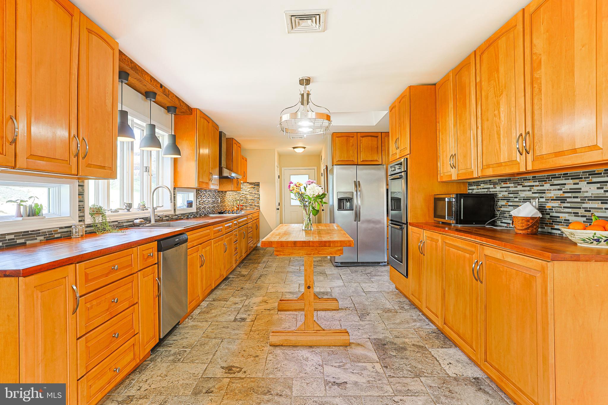 38 Devyn Drive Chester Springs, PA 19425 - Photo 18 of 40 a large kitchen with stainless steel appliances a large counter top a stove a chimney a sink and dishwasher