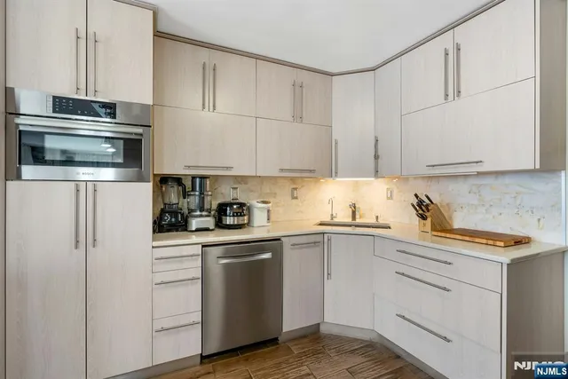 a bathroom with a white toilet sitting next to a white sink and a shower