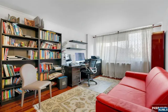 a living room with furniture potted plant and a large window