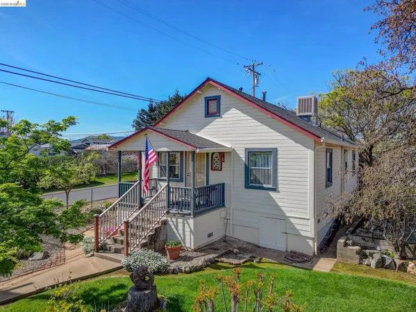 a front view of a house with outdoor seating