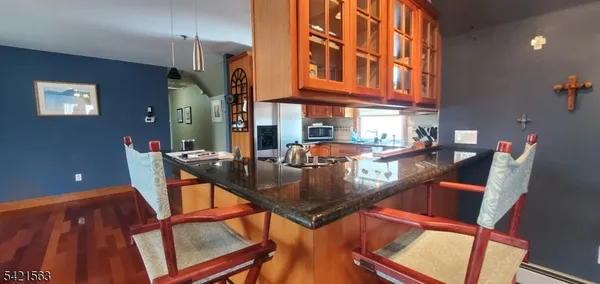 a living room with furniture a flat screen tv and kitchen view