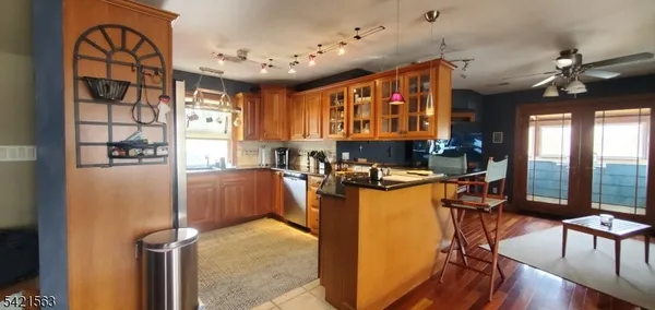 a bedroom with a bed and a walk in closet with wooden floor