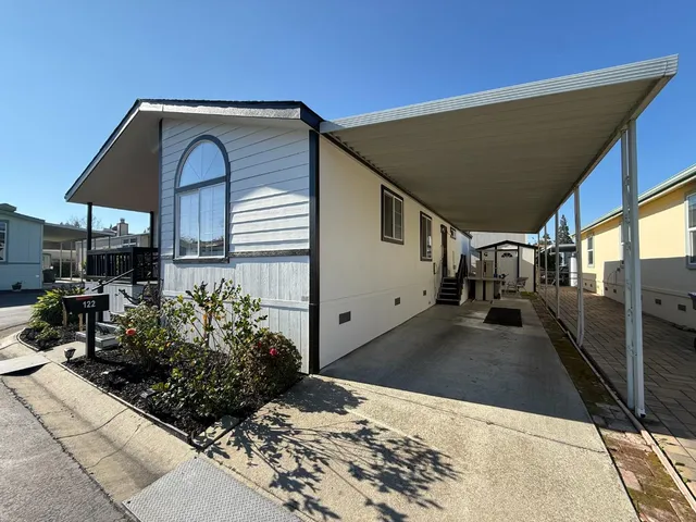 a kitchen with stainless steel appliances granite countertop a sink a stove and a refrigerator