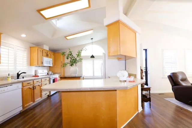 a view of a dining room with furniture and chandelier