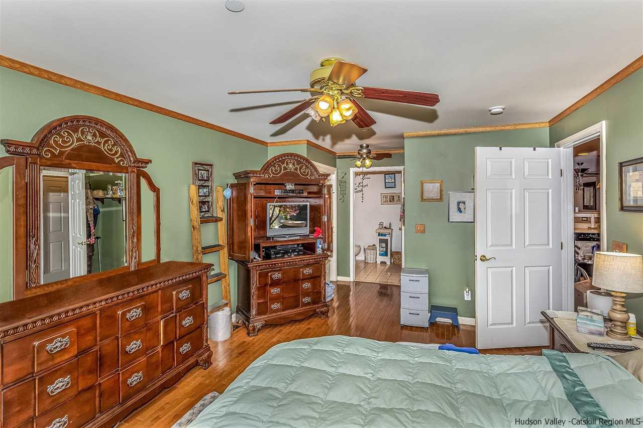 1129 Maggie Road Newburgh, NY 12550 - Photo 14 of 28 a bedroom with a bed and a chandelier