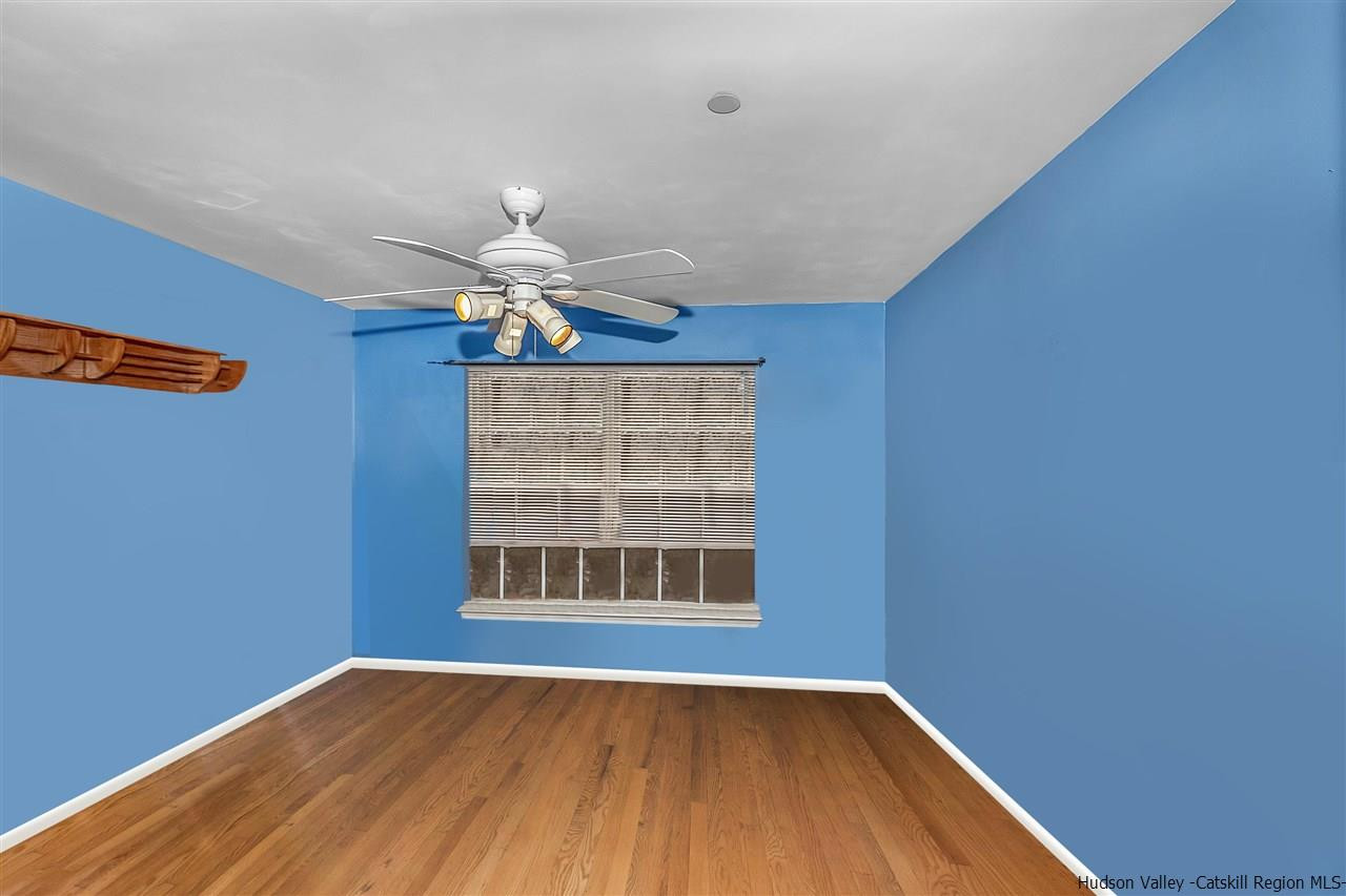 1129 Maggie Road Newburgh, NY 12550 - Photo 18 of 28 a view of an empty room with wooden floor and a window