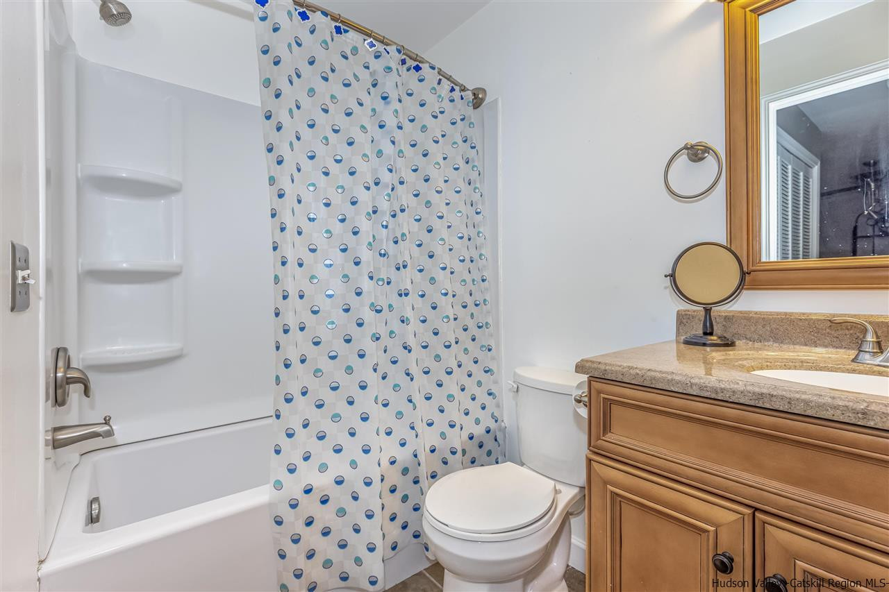 1129 Maggie Road Newburgh, NY 12550 - Photo 22 of 28 a bathroom with a granite countertop toilet a sink and a mirror