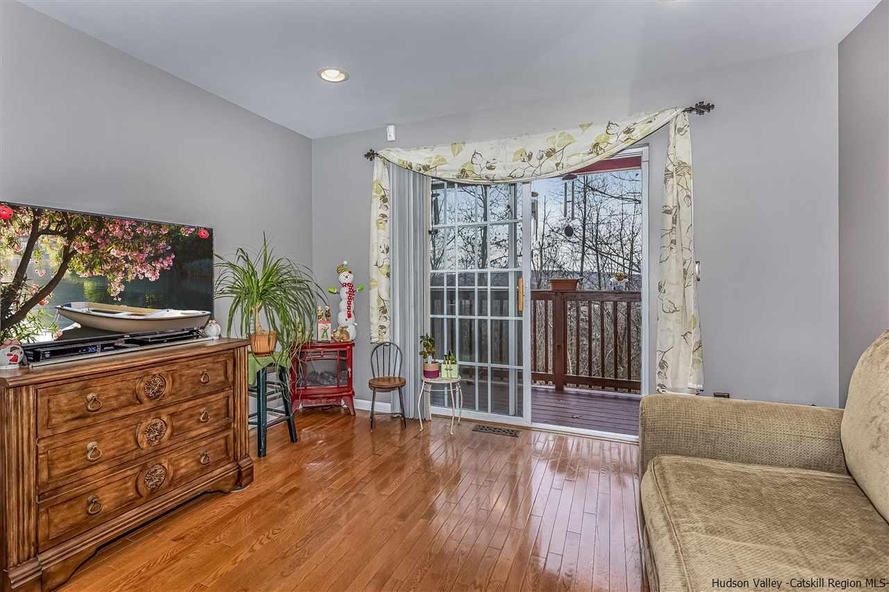 1129 Maggie Road Newburgh, NY 12550 - Photo 7 of 28 a living room with furniture a flat screen tv and a floor to ceiling window