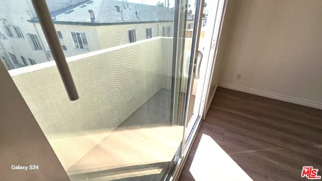 a view of a room with wooden floor