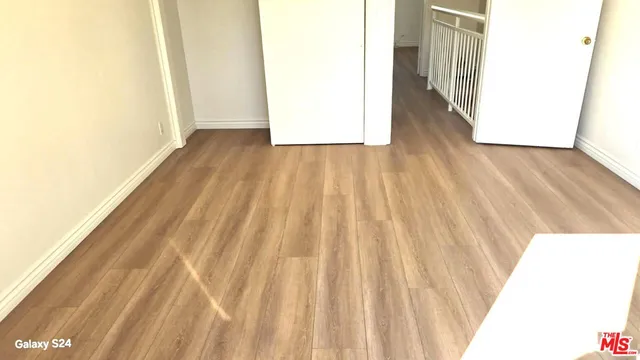 a view of a room with wooden floor