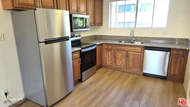 a kitchen with a refrigerator stove and sink