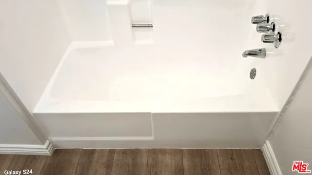 a bathroom with a sink a toilet and tub