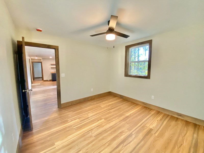 372 Angelico Ridge Murphy, NC 28906 - Photo 33 of 40 a view of empty room with wooden floor and fan