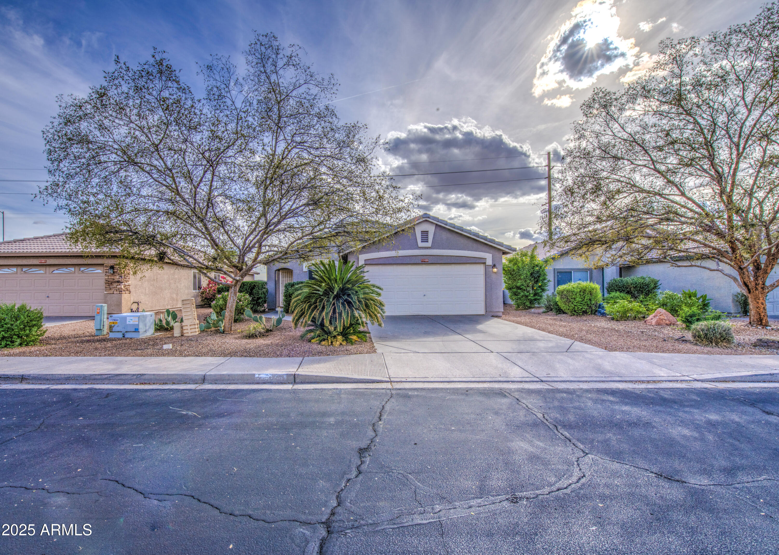 a front view of a house with a yard and a garage