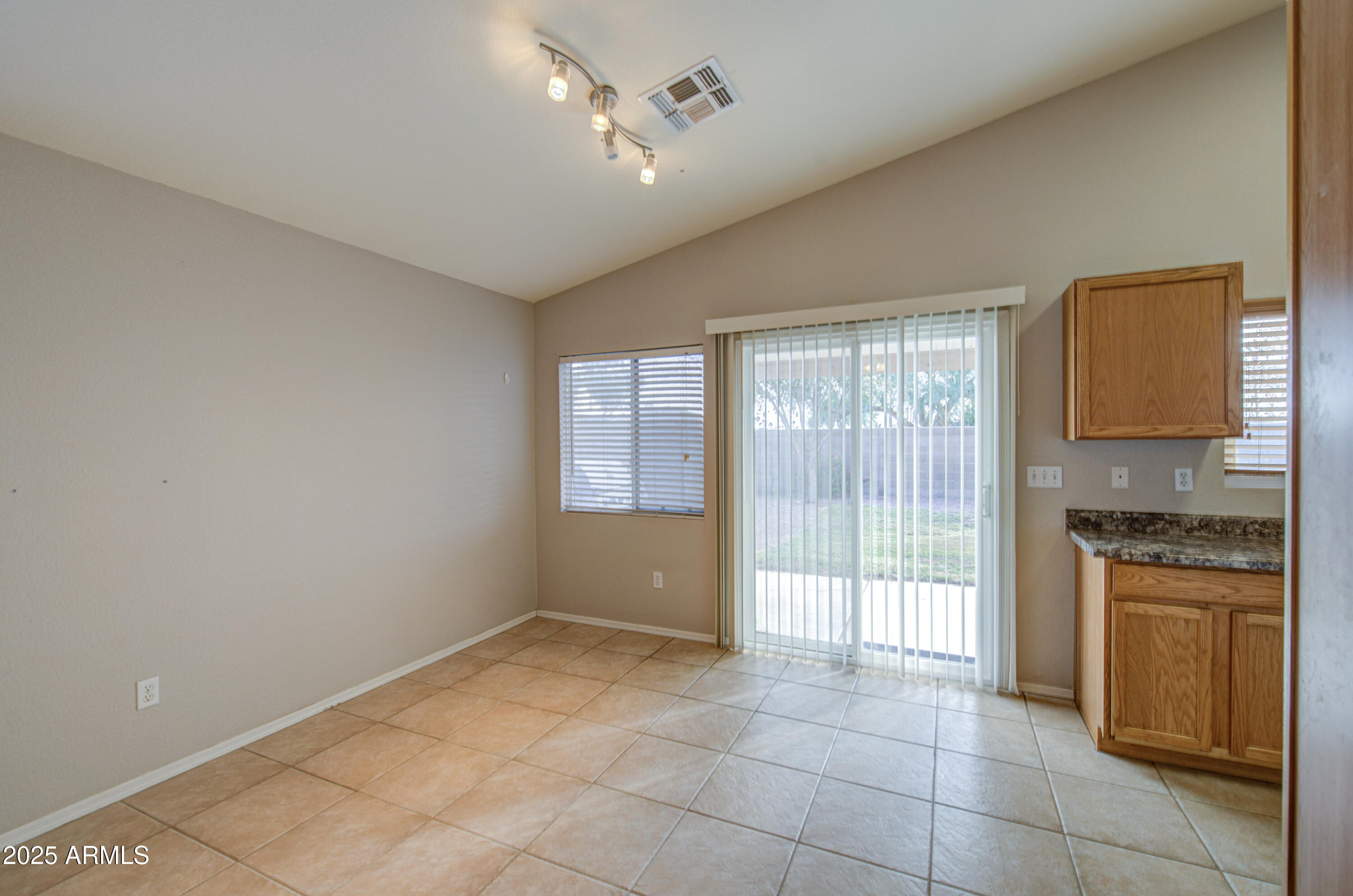 11465 East Cicero Street Mesa, AZ 85207 - Photo 11 of 36 a kitchen with a stove a refrigerator and ceiling cabinets