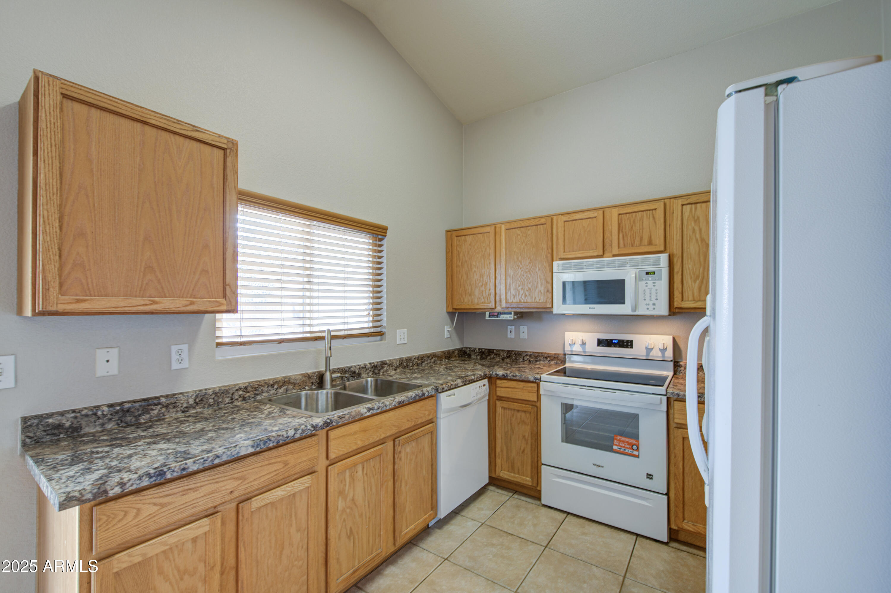 11465 East Cicero Street Mesa, AZ 85207 - Photo 13 of 36 a kitchen with stainless steel appliances granite countertop a sink stove and refrigerator
