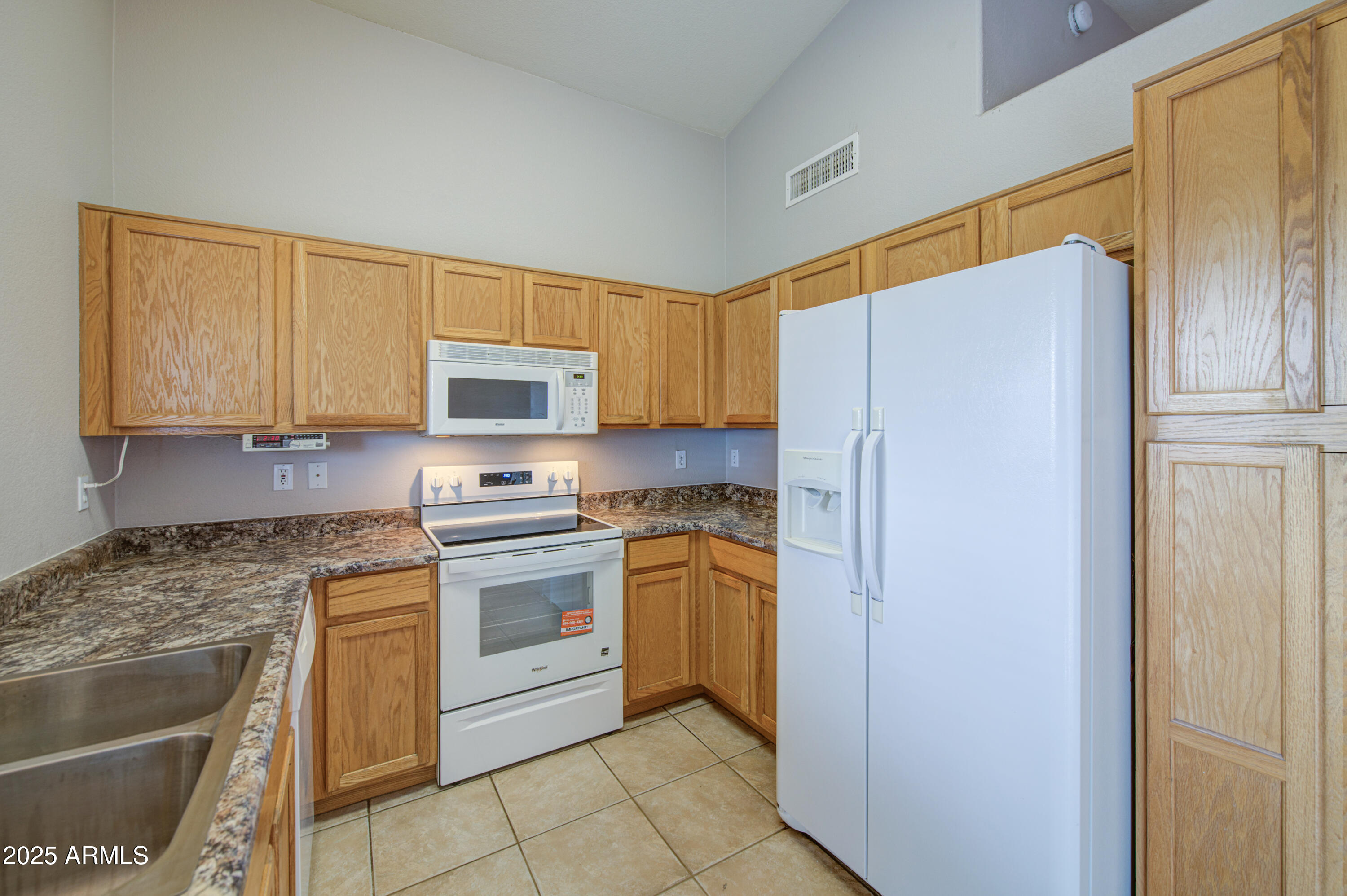 11465 East Cicero Street Mesa, AZ 85207 - Photo 14 of 36 a kitchen with stainless steel appliances granite countertop a refrigerator and a stove top oven