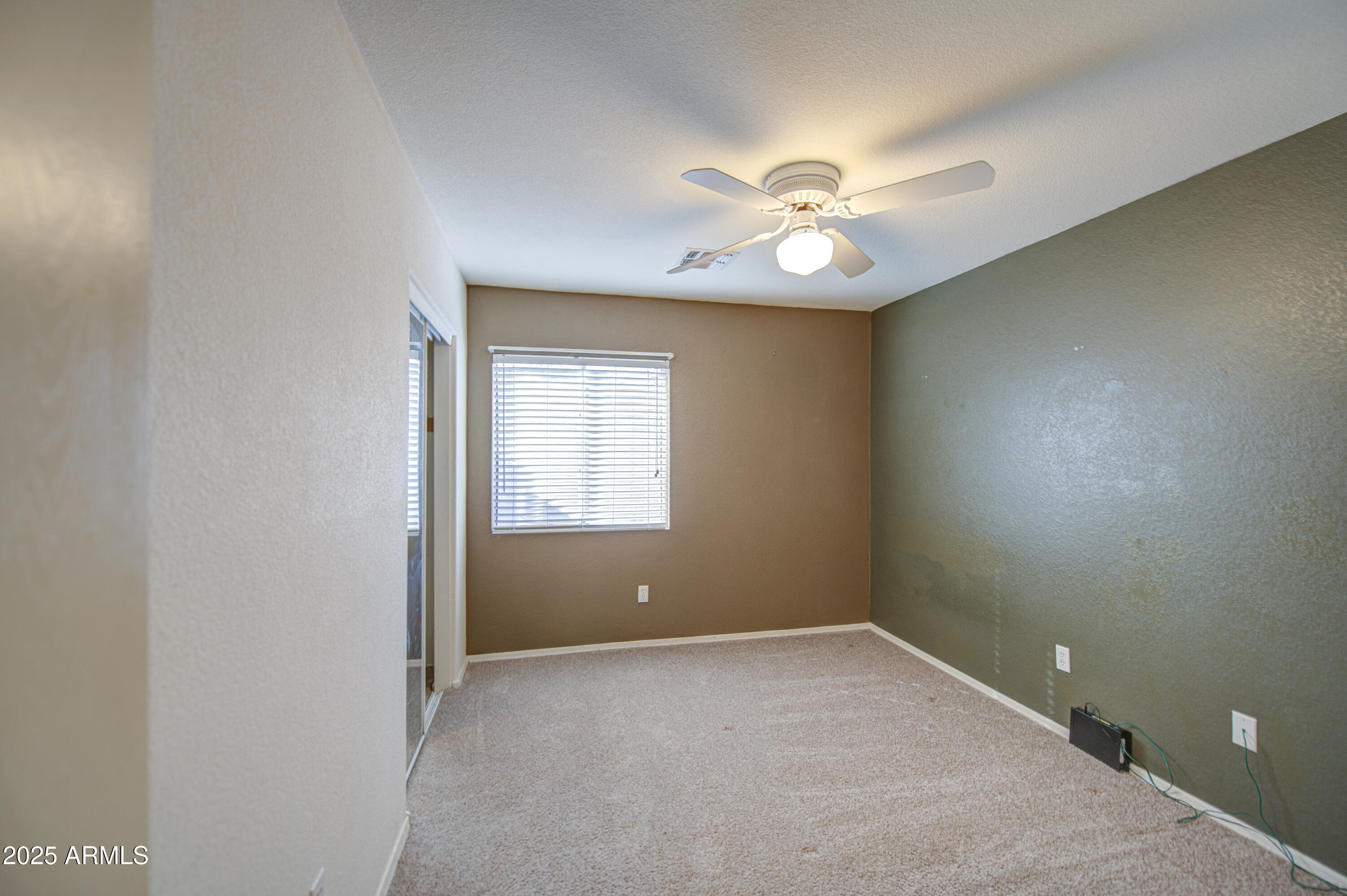 11465 East Cicero Street Mesa, AZ 85207 - Photo 26 of 36 an empty room with a window and ceiling fan