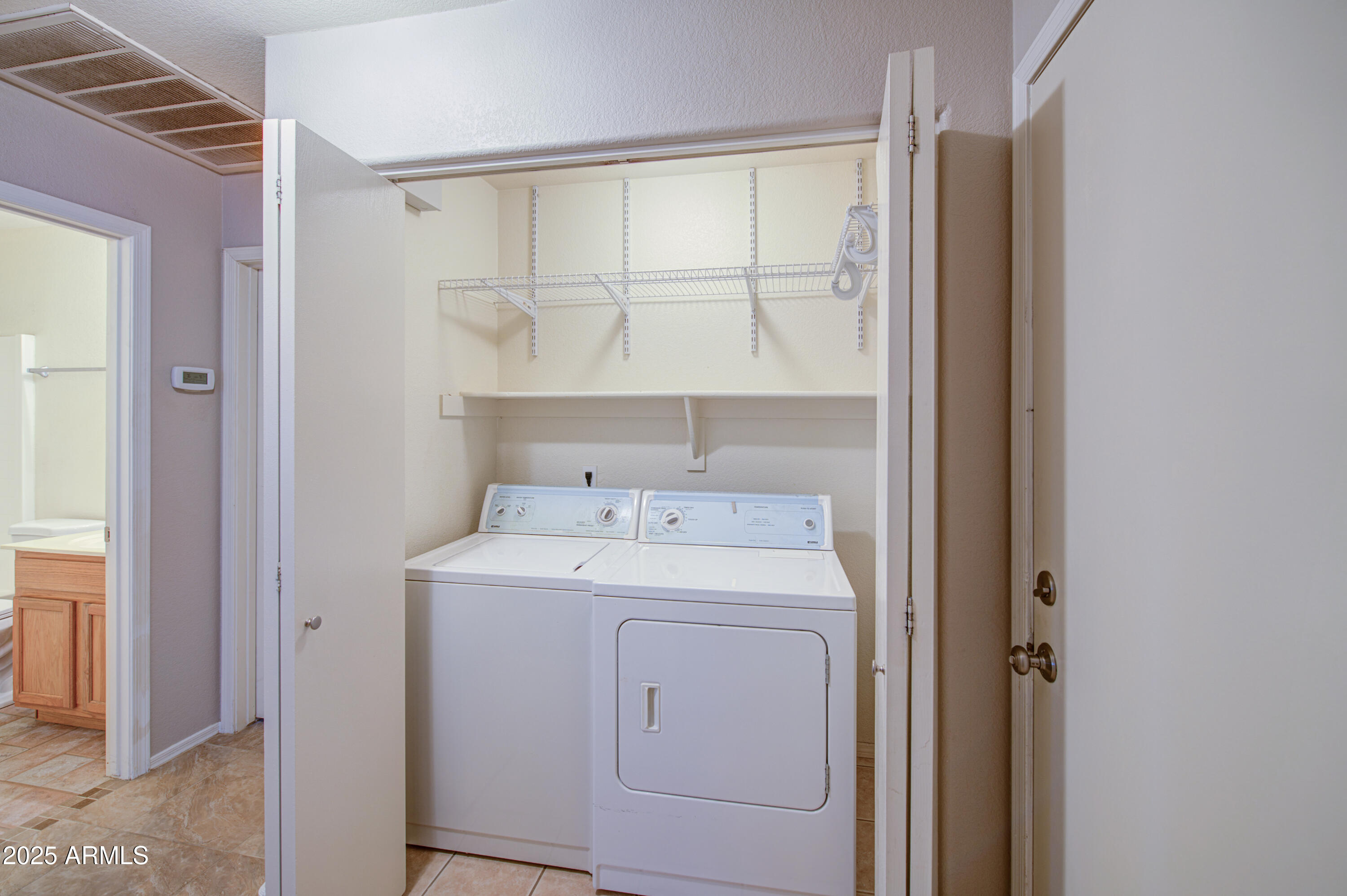 11465 East Cicero Street Mesa, AZ 85207 - Photo 30 of 36 a view of washer and dryer with bathroom in the background
