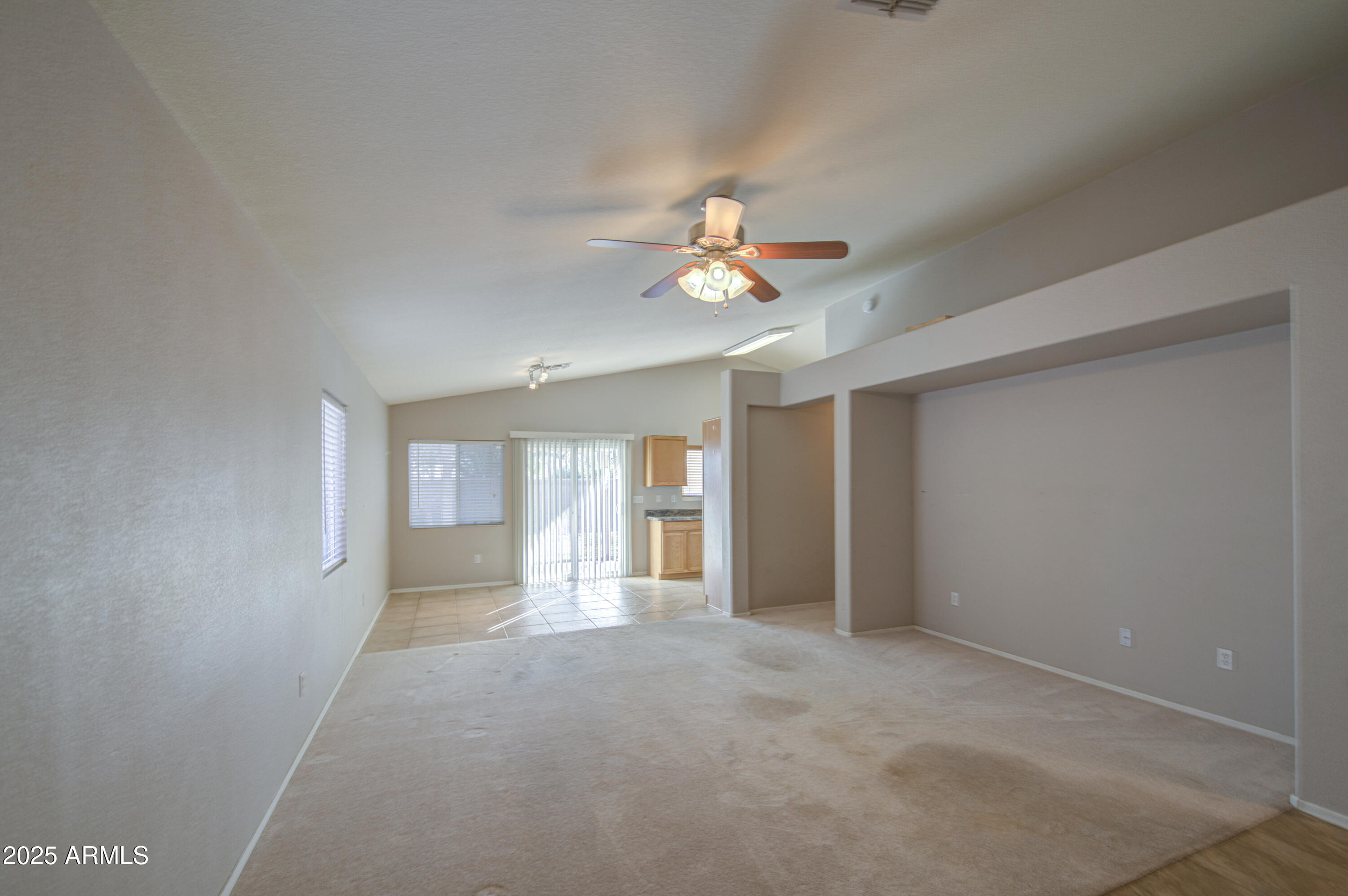 11465 East Cicero Street Mesa, AZ 85207 - Photo 7 of 36 en empty room with chandelier fan and windows