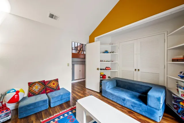 a living room with furniture and baby crib