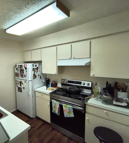 a kitchen with a stove and a refrigerator