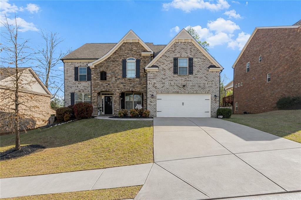 3820 Mabry Ridge Drive Buford, GA 30518 - Photo 2 of 55 a front view of a house with a yard