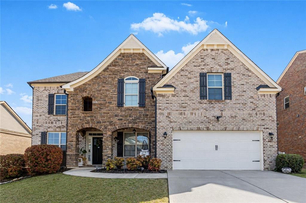 3820 Mabry Ridge Drive Buford, GA 30518 - Photo 3 of 55 a front view of a house with a garden