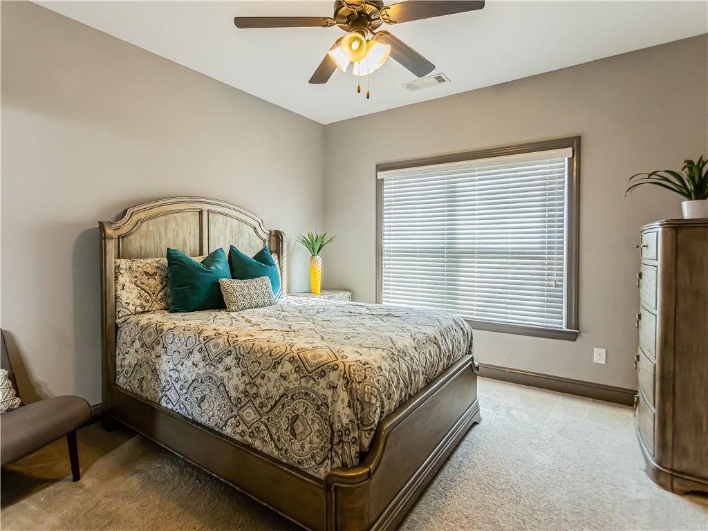 3820 Mabry Ridge Drive Buford, GA 30518 - Photo 38 of 55 a bedroom with a bed a window and a chandelier