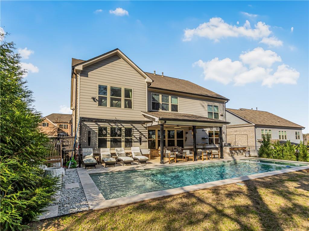 3820 Mabry Ridge Drive Buford, GA 30518 - Photo 49 of 55 a front view of a house with a yard table and chairs