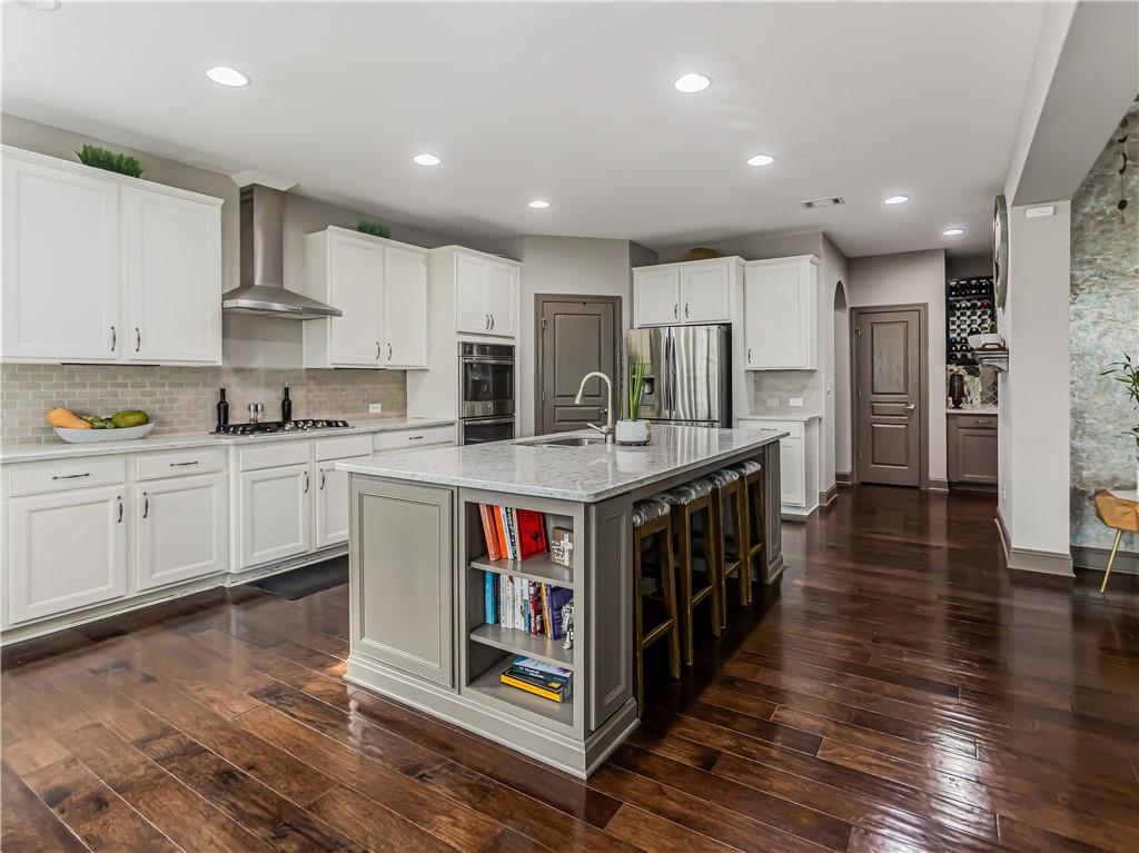 3820 Mabry Ridge Drive Buford, GA 30518 - Photo 5 of 55 a large kitchen with stainless steel appliances granite countertop a large center island and a stove