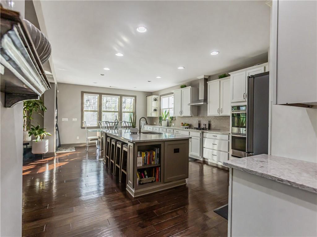 3820 Mabry Ridge Drive Buford, GA 30518 - Photo 9 of 55 a kitchen with stainless steel appliances granite countertop a stove and a refrigerator