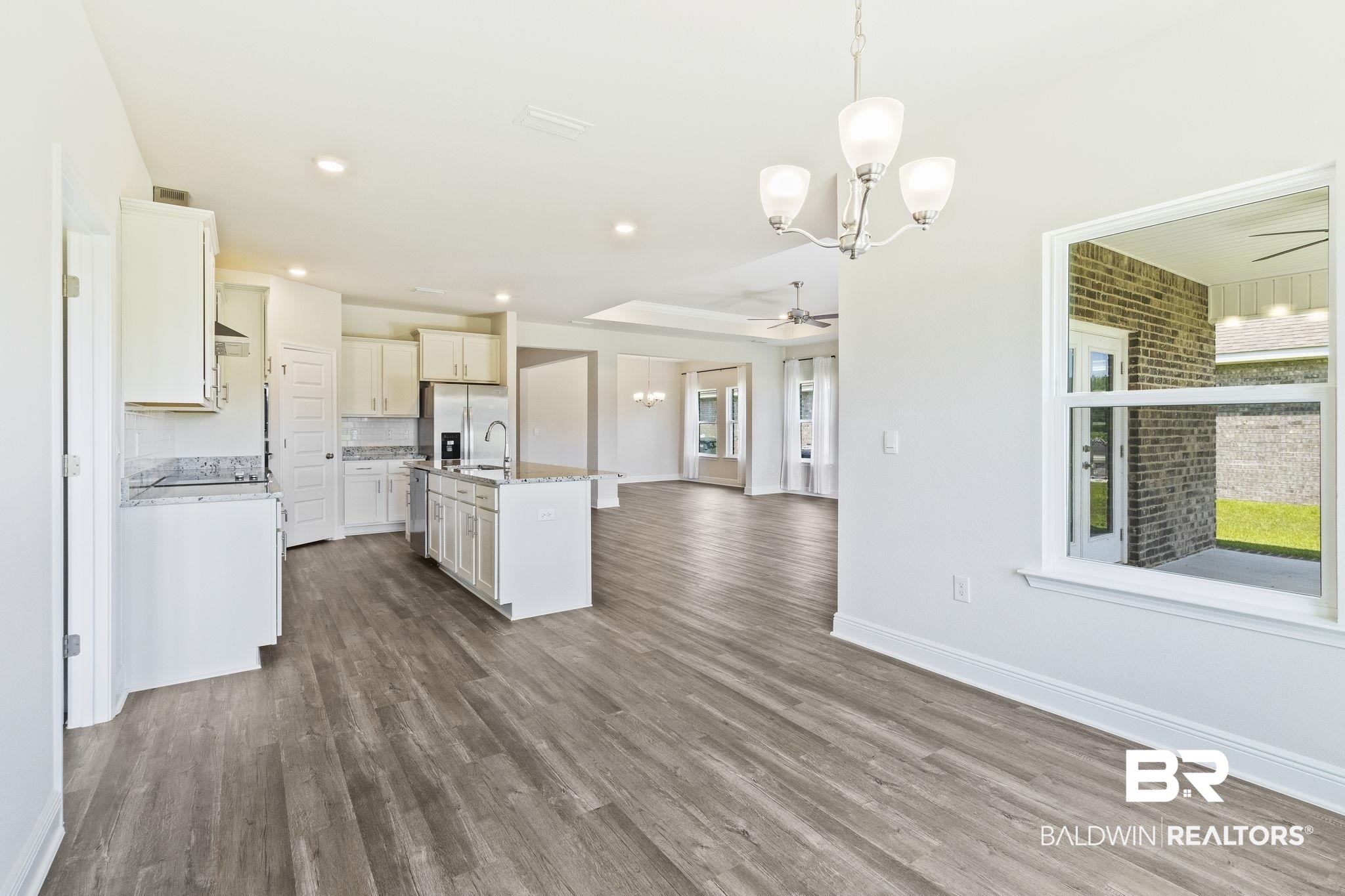 11303 Genuine Risk Circle Daphne, AL 36526 - Photo 29 of 100 Kitchen with dark wood-type flooring and ceiling fan with notable chandelier