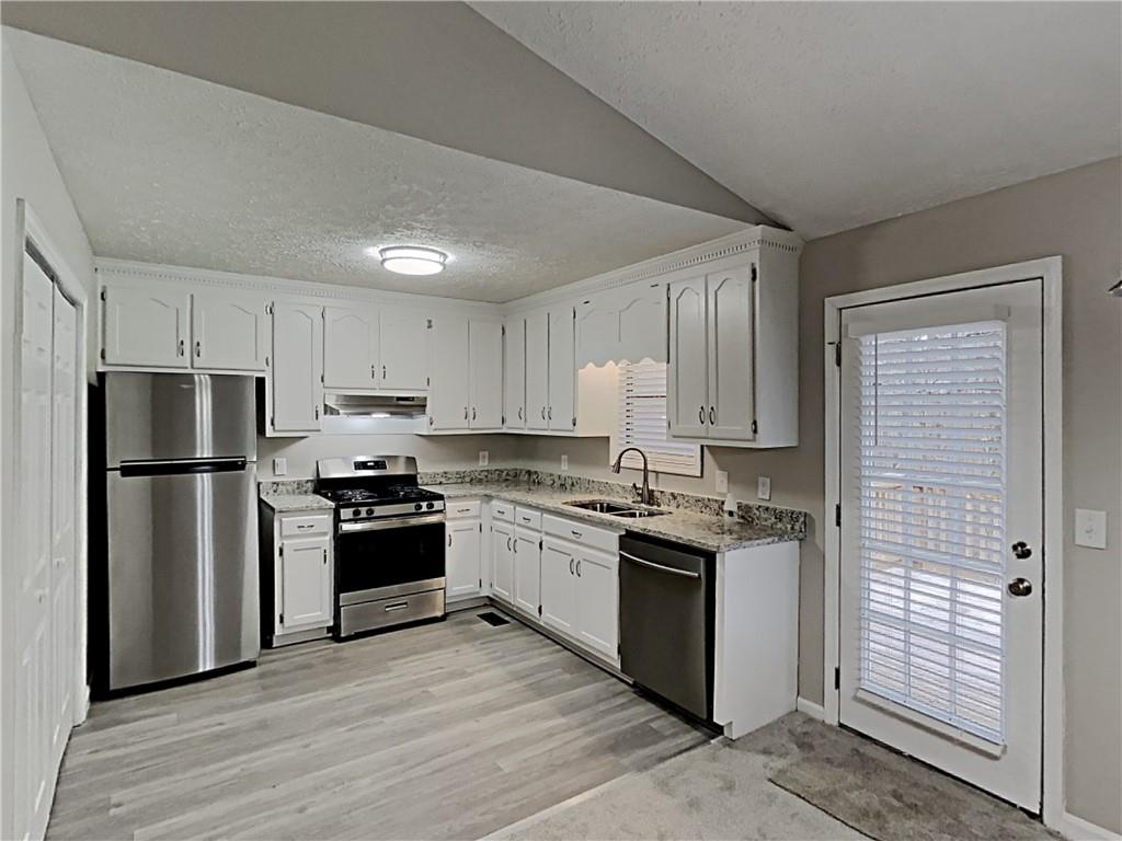 3548 Cherokee Overlook Drive Canton, GA 30115 - Photo 13 of 24 a kitchen with a stove a refrigerator and a sink