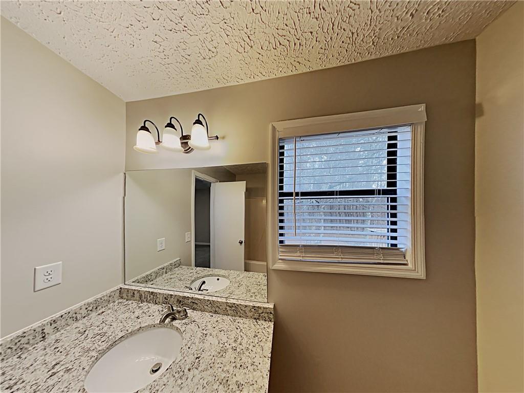 3548 Cherokee Overlook Drive Canton, GA 30115 - Photo 23 of 24 a bathroom with a sink and a mirror