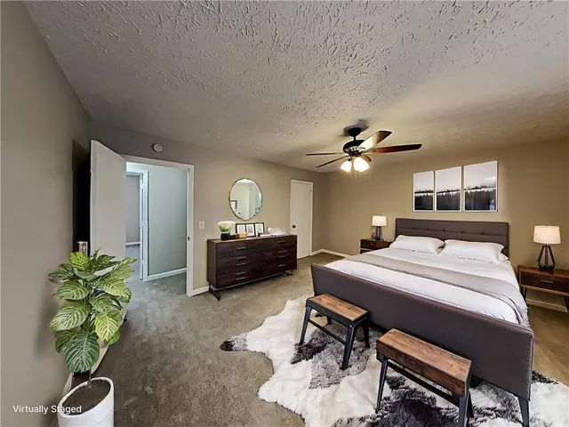 a living room with furniture a chandelier and a potted plant