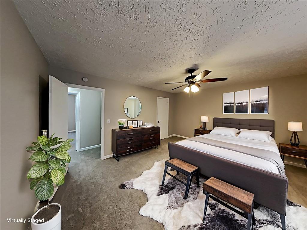 3548 Cherokee Overlook Drive Canton, GA 30115 - Photo 3 of 24 a living room with furniture a chandelier and a potted plant