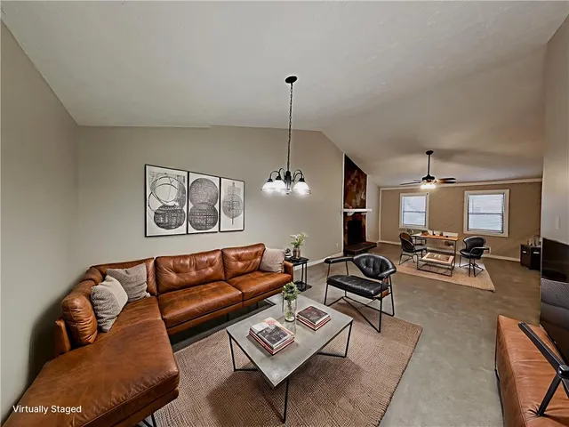 a living room with furniture a rug and a chandelier