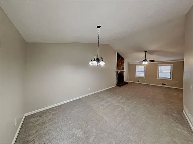 a view of a room with a ceiling fan and window