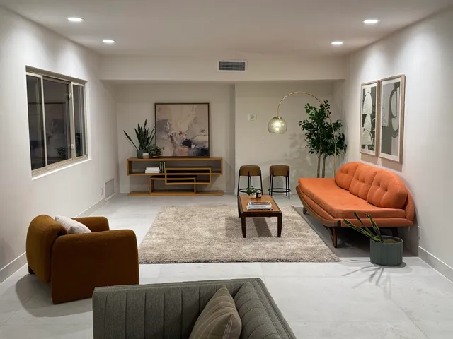 a living room with furniture and a potted plant