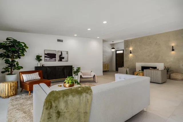 a living room with furniture and flowers