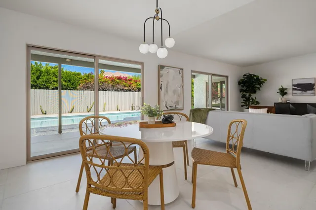 a view of a dining room with furniture wooden floor and chandelier