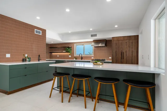 a kitchen with a table chairs refrigerator and cabinets