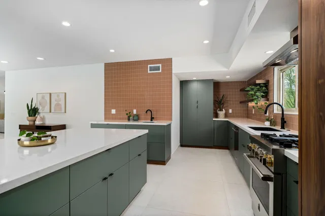 a kitchen with stainless steel appliances a sink stove and refrigerator