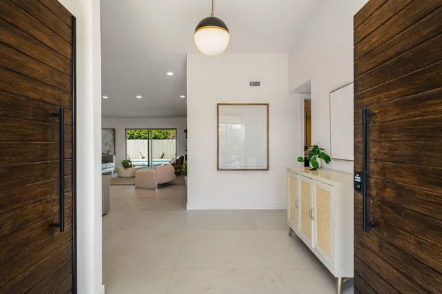 a hall way with furniture and a gate