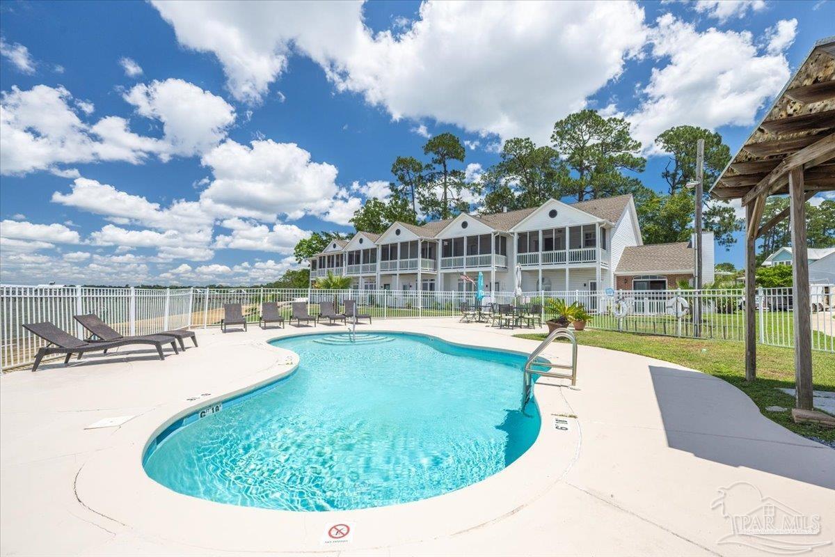 26063 Canal Road, Unit 3F Orange Beach, AL 36561 - Photo 63 of 72 a view of a swimming pool with outdoor seating